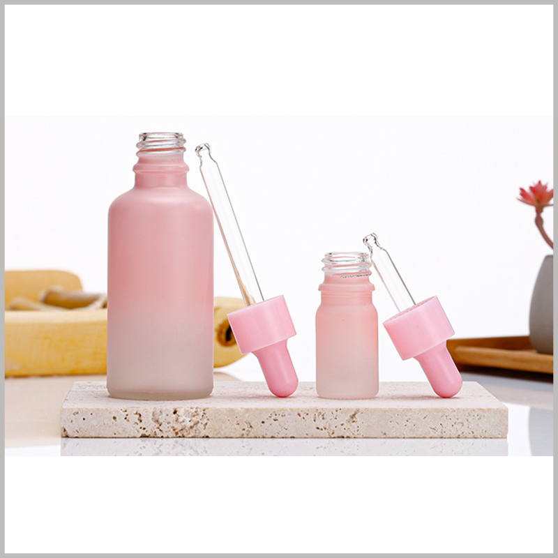 Fashion Gradient Pink glass dropper bottles consist of thick glass body, pink rubber, pink circle and dropper