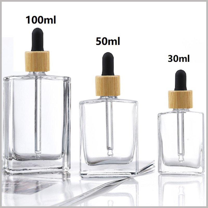 Flat square clear essential oil dropper bottle with wooden lids. According to actual needs, choose one or more of different essential oil bottle capacities such as 15ml, 30ml, 50ml, 100ml.