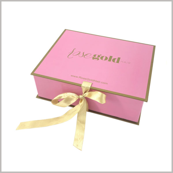 Foldable hard cardboard gift boxes for wig packaging,Pink outer packaging background, yellow narrow silk cloth as a gift knot, has been chased by female consumers.