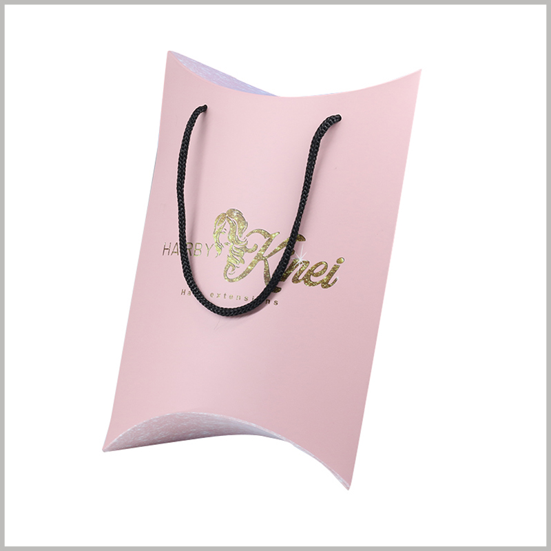 Pink pillow boxes for hair bundles packaging. The pattern and brand name of the wig can be printed by bronzing, which is reflected on the surface of the customized packaging to strengthen the promotion of the product.