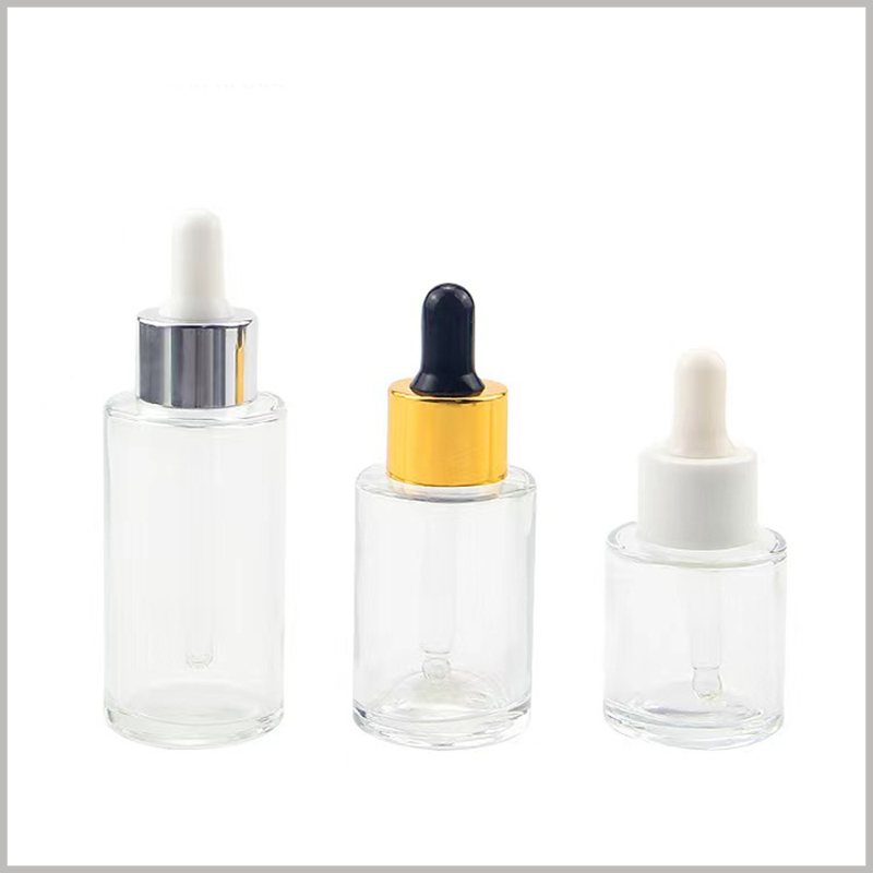 Round flat shoulder clear glass dropper bottle for essential oil. The circle is available in anodized aluminum gold, silver, and plastic white.