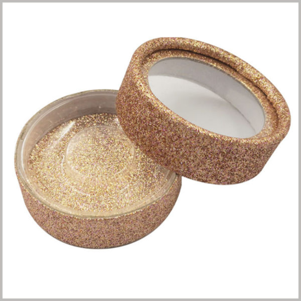 Shinny false eyelash tube packaging box with transparent window. The outside and inside of the paper tube are decorated with shiny gold cardboard to make the false eyelashes look more high-end.