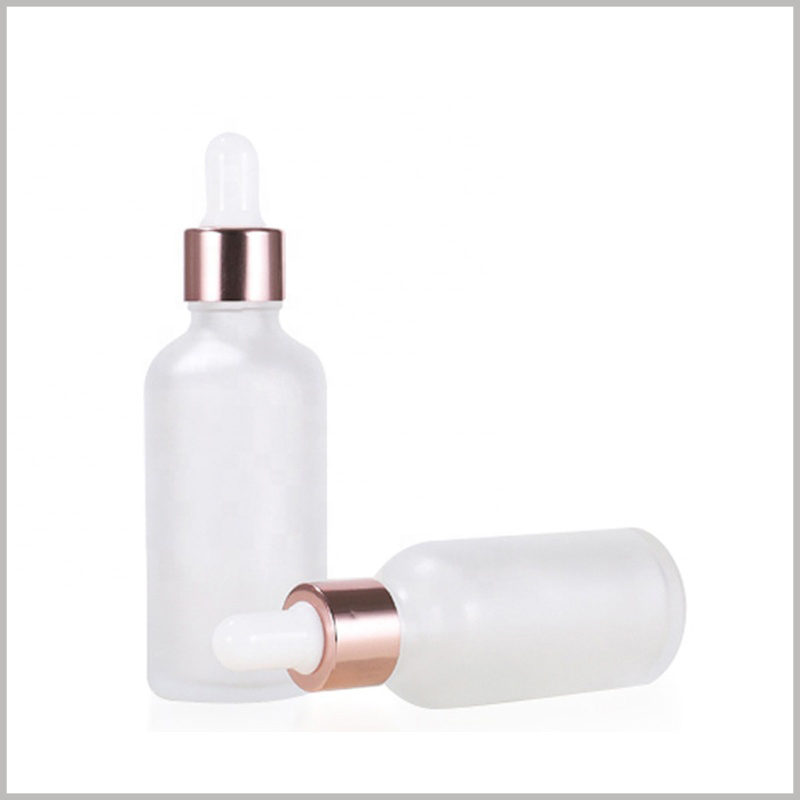 White Essential Oil Scrub Dropper Bottle with Rose Gold Circle. Essential oil bottles have a stylish look and are very popular.