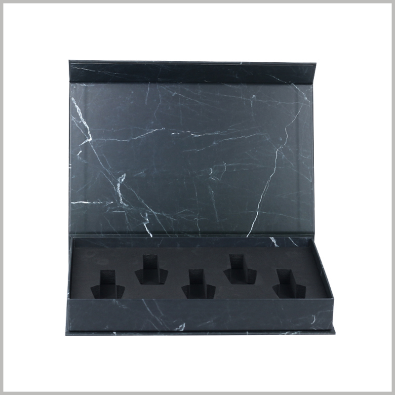 black cardboard boxes for 5 bottles nail polish packaging. The interior of the cosmetic packaging is a specially designed EVA so that the nail polish is arranged inside the box in a specific form.