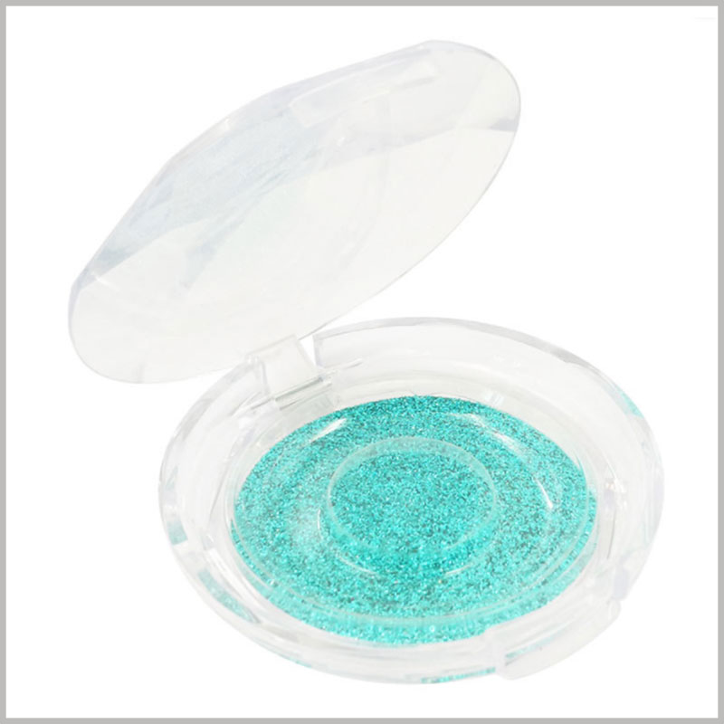 clear round mink eyelash box packaging.The sparkling green art paper is at the bottom of the eyelash packaging, which increases the attractiveness of the packaging and the product