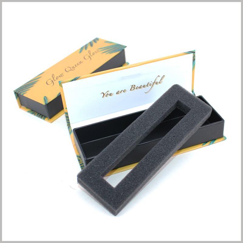 custom flip packaging for lip gloss boxes. The black sponge is used as an insert to protect the fragile lip gloss glass bottle.