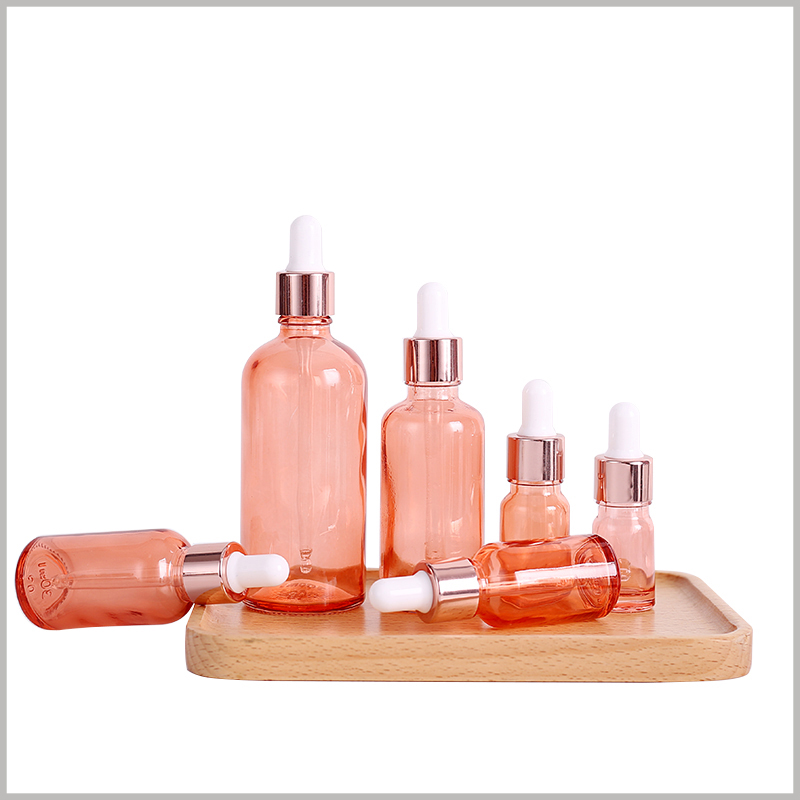 custom pink essential oil bottles with dropper, with 5-100ml capacity to choose, and the diameter and height of the bottles are different.