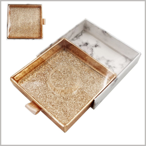 custom small square cardboard drawer eyelash boxes with windows. The drawer inner box uses shiny gold cardboard as the laminated paper to make the packaging more luxurious.