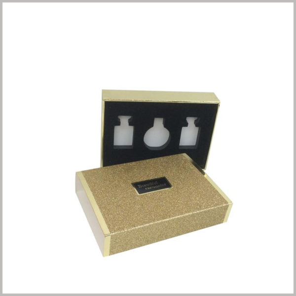 gold cardboard boxes for 3 bottles of perfume packaging.The black flocked EVA has three different hollow shapes for three different types of perfume.