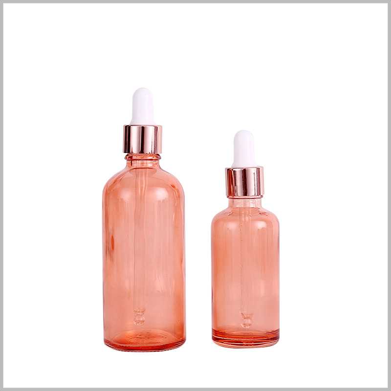 The pink essential oil bottle with dropper, the combination of golden circle and white rubber, is one of the choices of many customers.