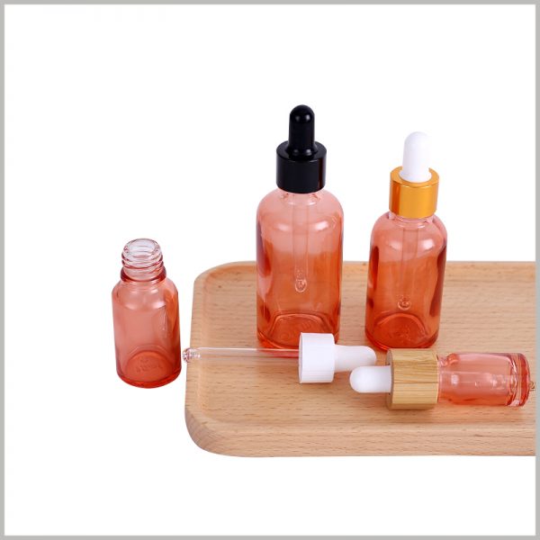 Pink essential oil bottles with dropper wholesale, the circle has black plastic, gold anodized aluminum, wooden circle, etc.; rubber can choose black and white.