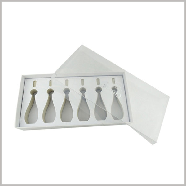 white cardboard packaging for 6 bottles nail polish. The top cover of makeup boxes is completely composed of clear pvc, forming a transparent window to satisfy customers' desire to peek at products.