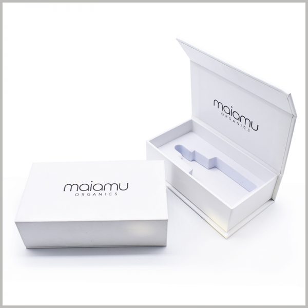 White cardboard packaging for essential oil with EVA insert. The custom essential oil packaging features a minimalist white theme with just the brand name and information printed on it.