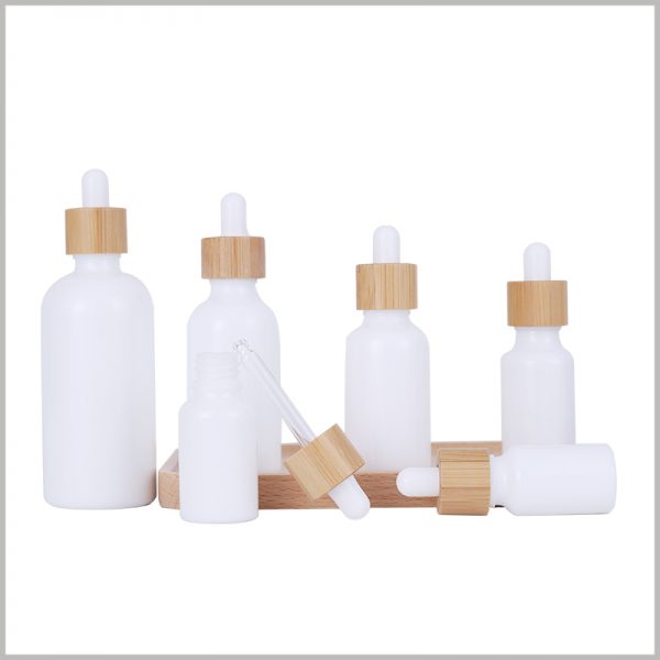 white essential oil dropper bottles with wooden cap. Stylish essential oil bottles are very helpful for product and brand promotion.